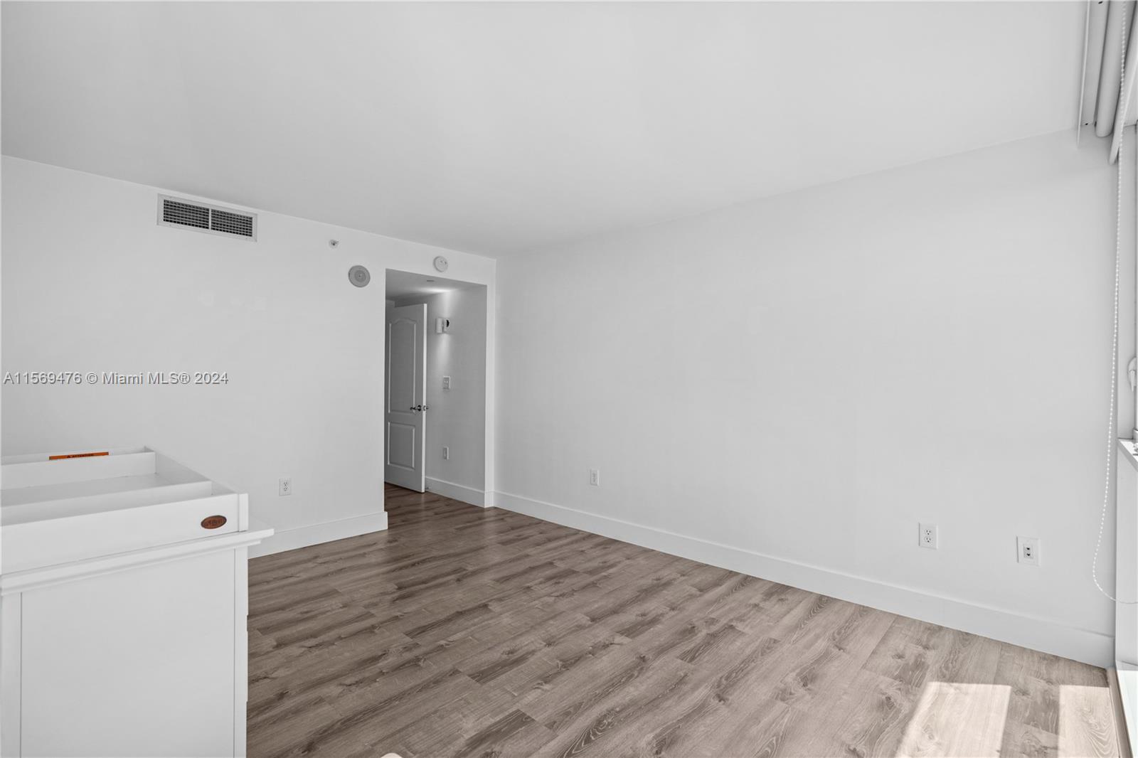 2101 Brickell Avenue, Unit 2012 Miami, FL 33129 - Photo 11 of 44 a view of utility room with closet and wooden floor