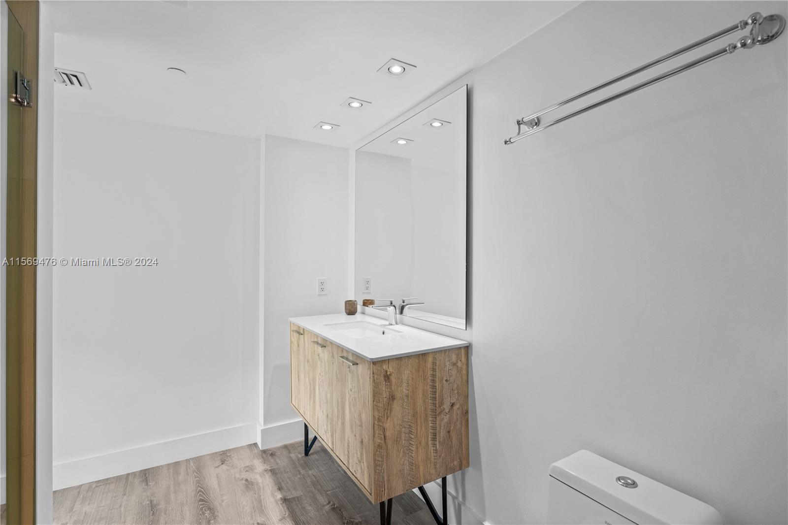 2101 Brickell Avenue, Unit 2012 Miami, FL 33129 - Photo 19 of 44 a bathroom with a sink a toilet a mirror and shower