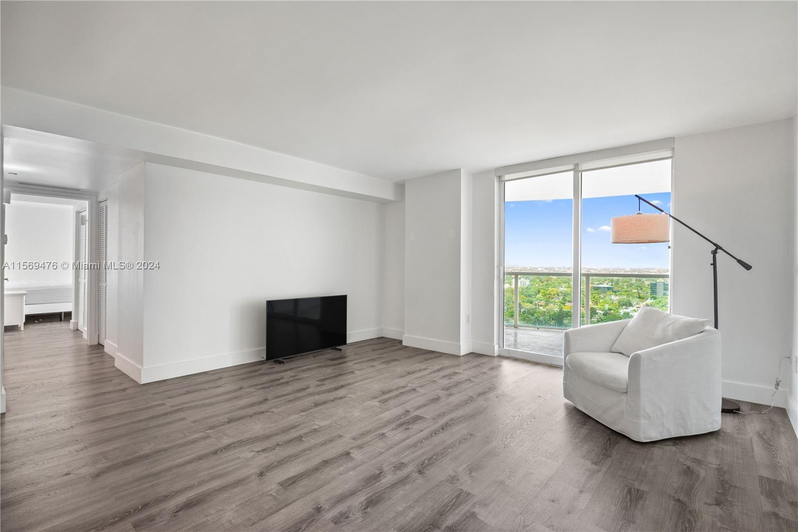 2101 Brickell Avenue, Unit 2012 Miami, FL 33129 - Photo 29 of 44 a view of an empty room with wooden floor and a window
