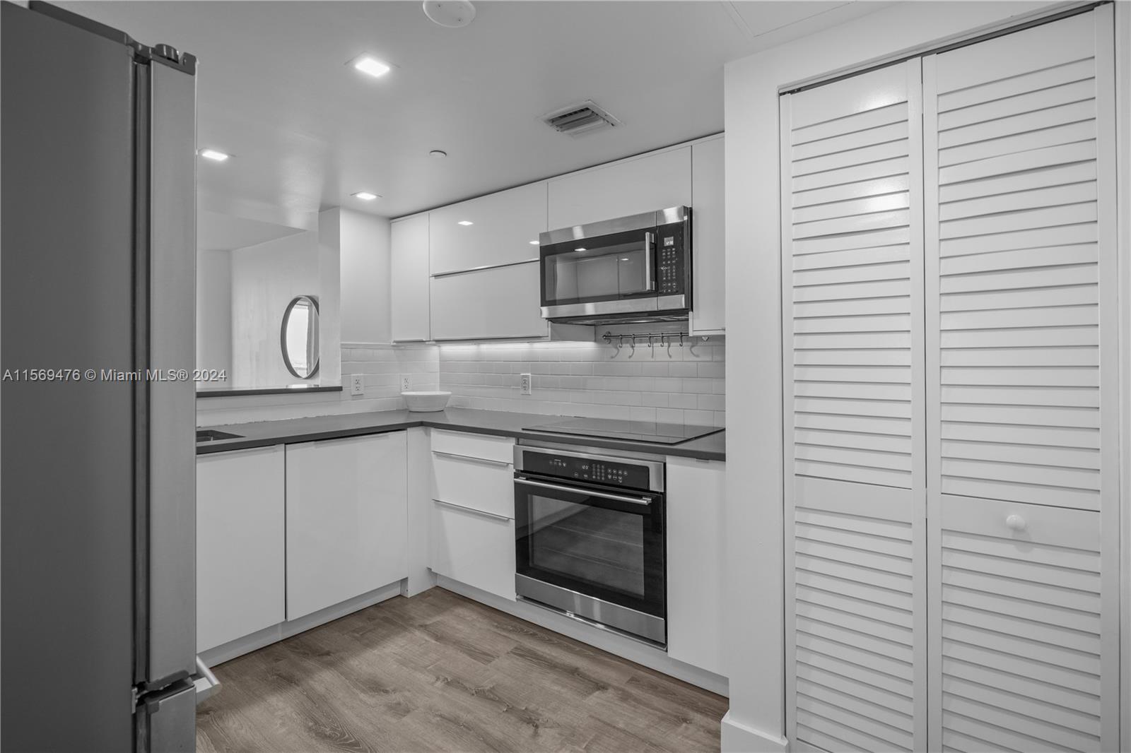 2101 Brickell Avenue, Unit 2012 Miami, FL 33129 - Photo 40 of 44 a kitchen with stainless steel appliances granite countertop a stove a microwave and a refrigerator