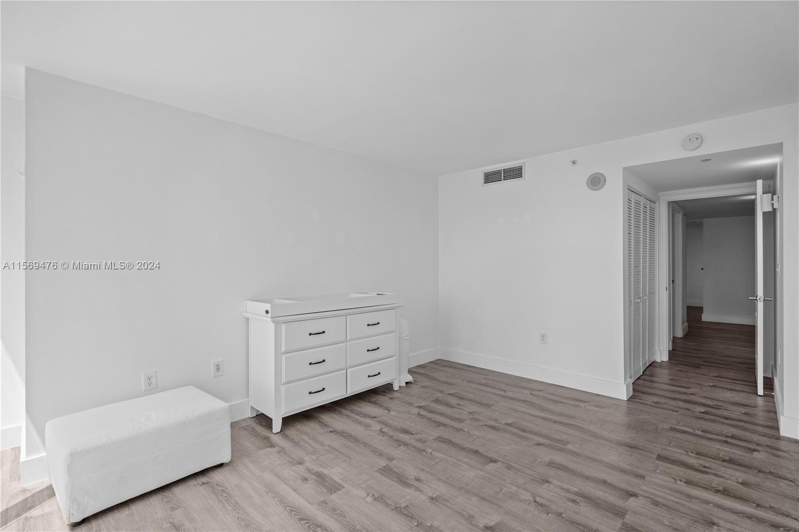 2101 Brickell Avenue, Unit 2012 Miami, FL 33129 - Photo 9 of 44 a room with a baby bed baby crib and a dresser