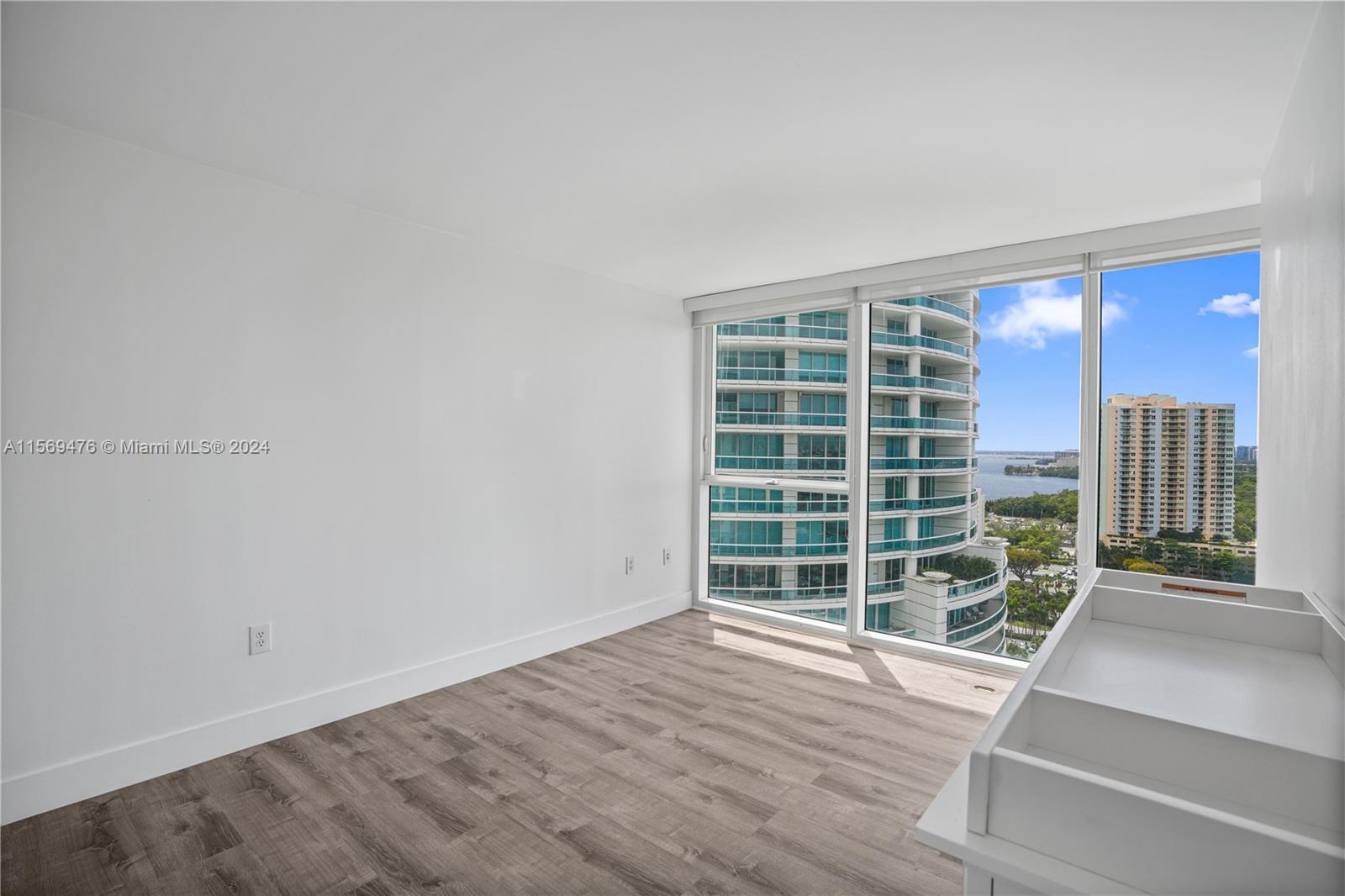 2101 Brickell Avenue, Unit 2012 Miami, FL 33129 - Photo 10 of 44 an empty room with wooden floor and windows