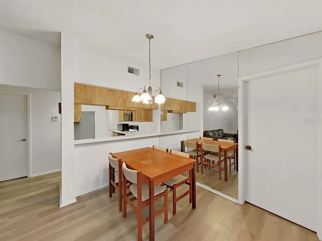 a living room with kitchen island furniture and wooden floor