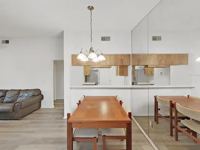 a living room with furniture a table and chairs