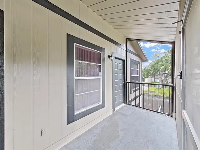 a view of front door with a balcony