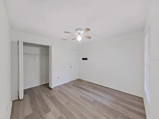 a bathroom with a sink a toilet a mirror and shower