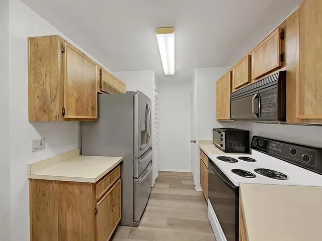 a kitchen with a sink stove and microwave