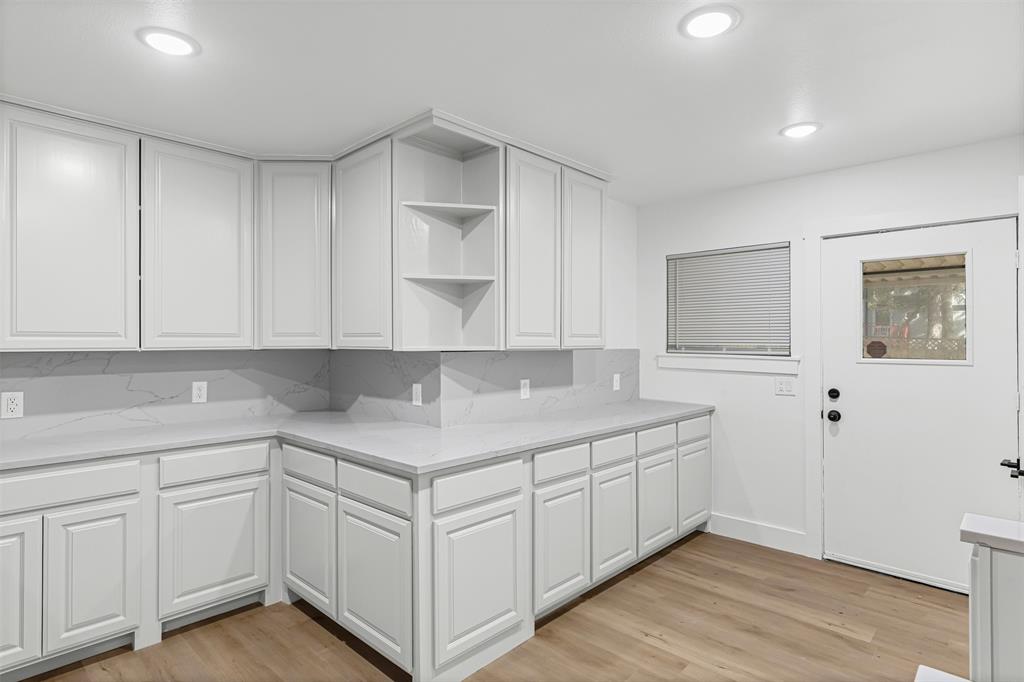 1509 Shirley Way Bedford, TX 76022 - Photo 10 of 26 Kitchen with open shelves, white cabinets, light wood-style flooring, backsplash, and recessed lighting