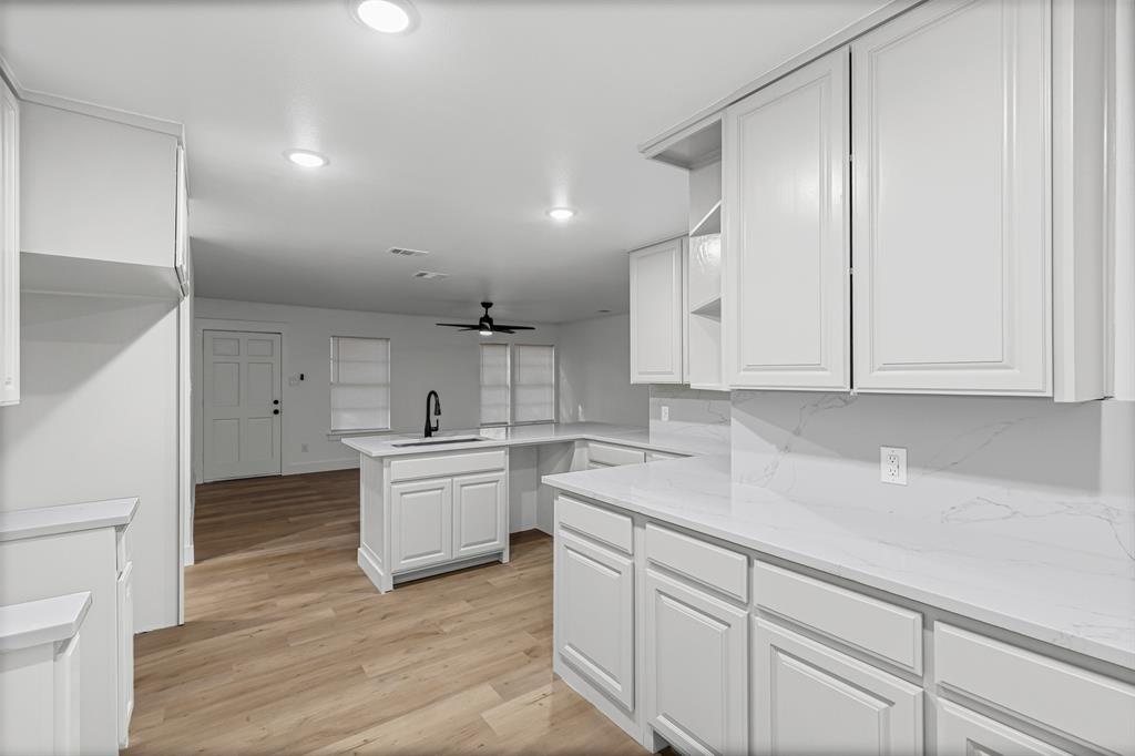 1509 Shirley Way Bedford, TX 76022 - Photo 11 of 26 Kitchen featuring open shelves, light wood-style flooring, white cabinetry, recessed lighting, and a ceiling fan