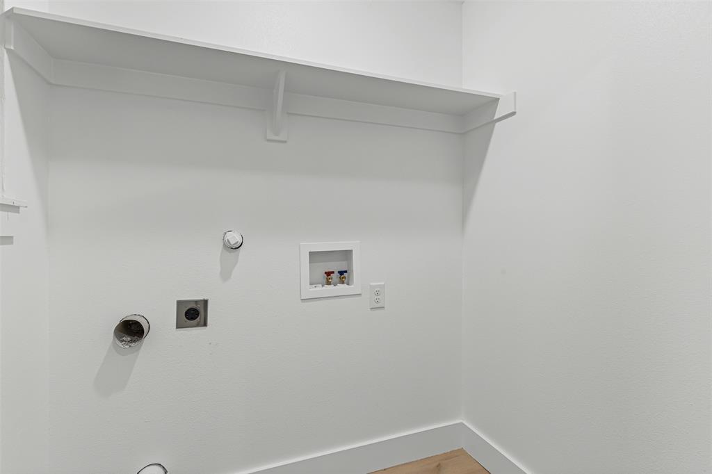1509 Shirley Way Bedford, TX 76022 - Photo 13 of 26 Laundry area with gas dryer hookup, washer hookup, electric dryer hookup, and wood finished floors
