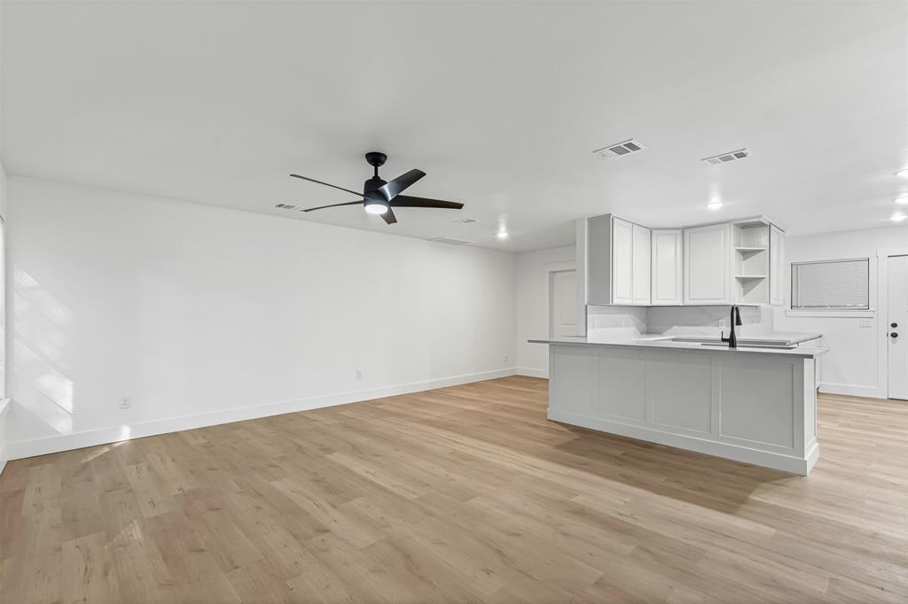 1509 Shirley Way Bedford, TX 76022 - Photo 26 of 26 Kitchen with white cabinets, light wood-style flooring, open shelves, ceiling fan, and open floor plan