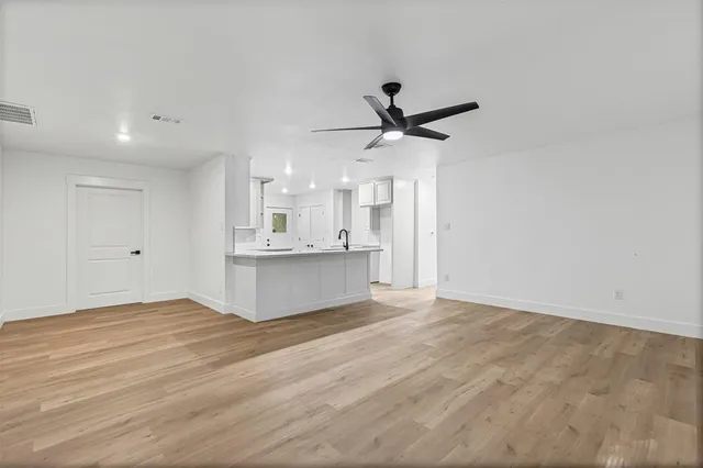 a view of kitchen with sink and refrigerator