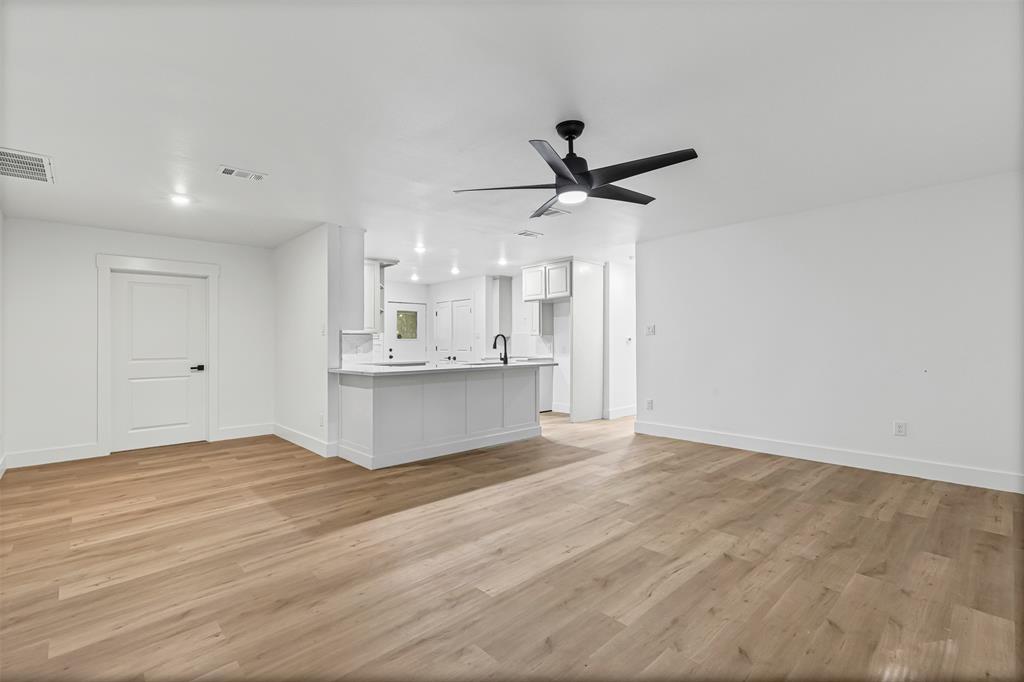 1509 Shirley Way Bedford, TX 76022 - Photo 4 of 26 Unfurnished living room with light wood finished floors and ceiling fan