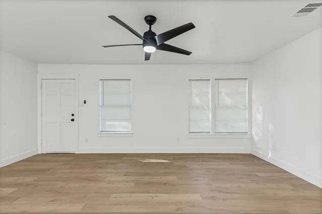 wooden floor in an empty room with a window