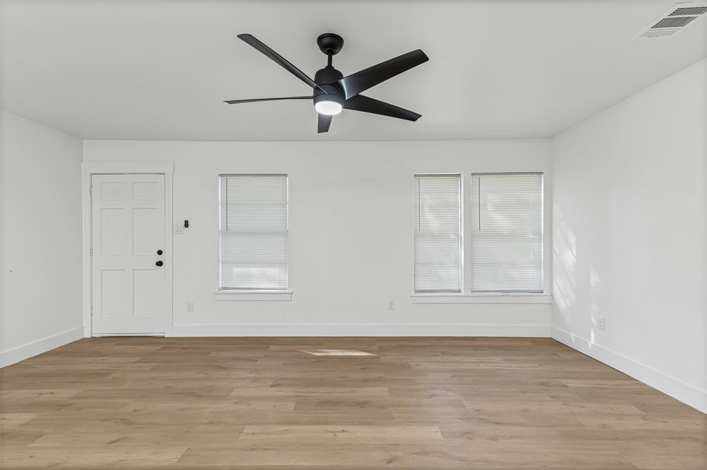 1509 Shirley Way Bedford, TX 76022 - Photo 6 of 26 Empty room with light wood-style flooring and ceiling fan