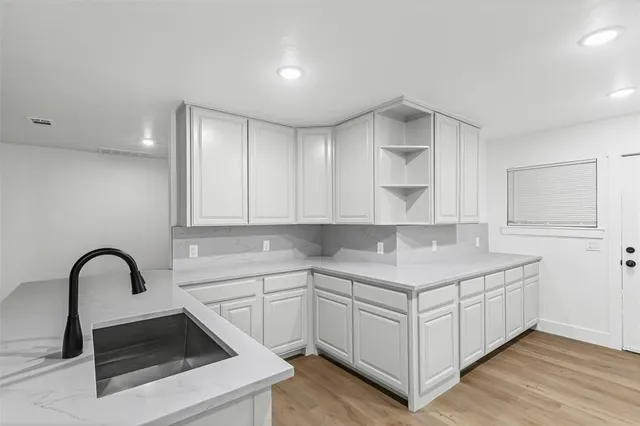 a view of cabinets a sink and dishwasher in a room