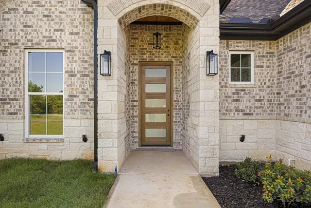 a view of front door of a house with a yard