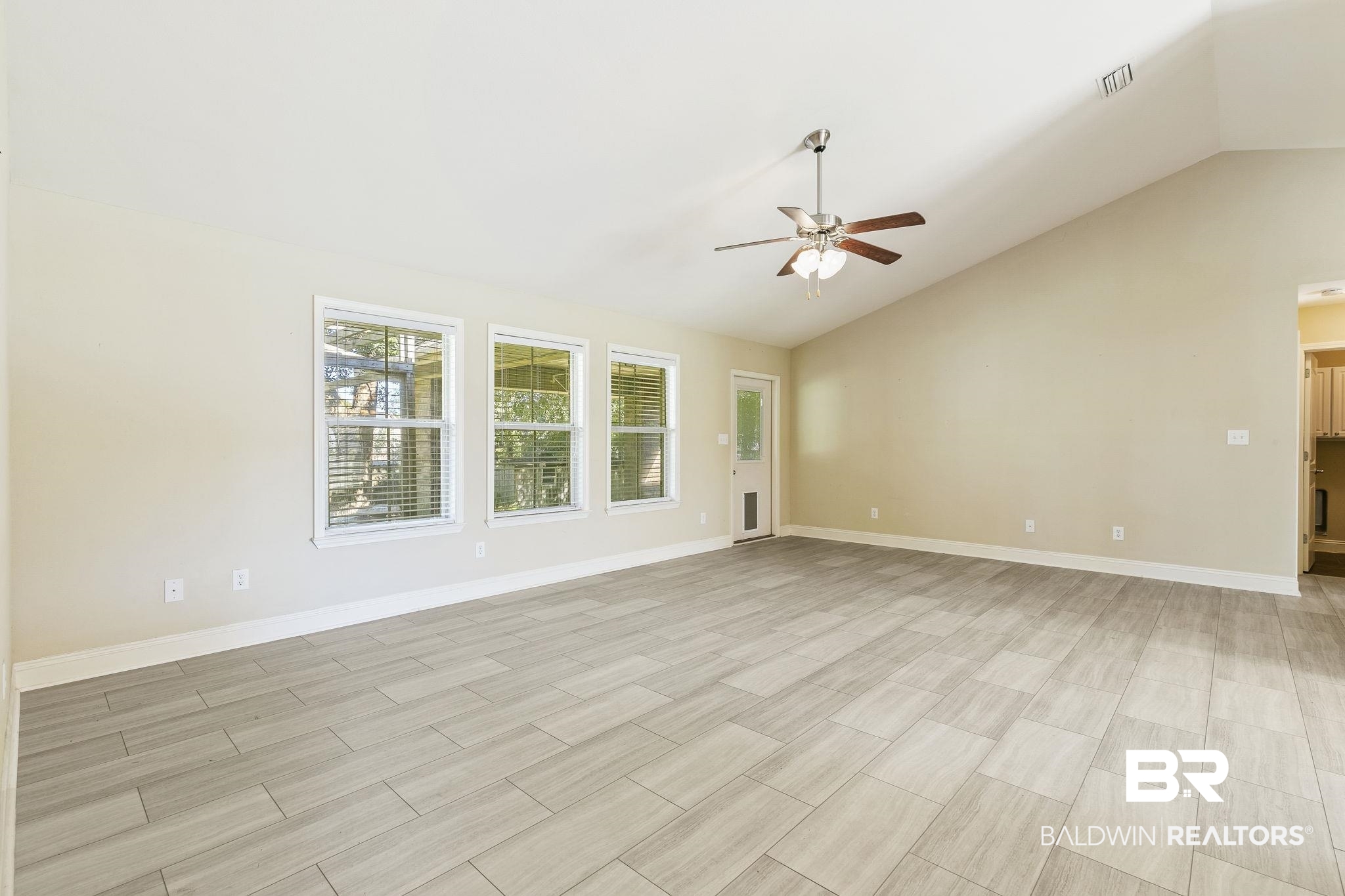 11153 Sturbridge Loop Daphne, AL 36526 - Photo 25 of 79 Unfurnished living room featuring ceiling fan and vaulted ceiling