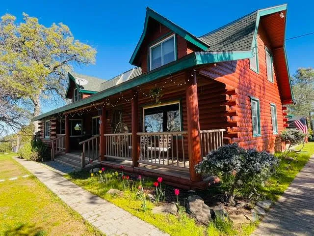 a view of house with a yard