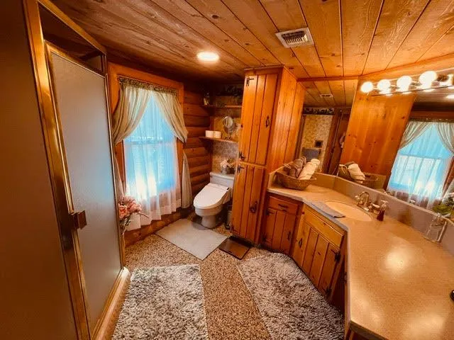 a bedroom with furniture and a large window