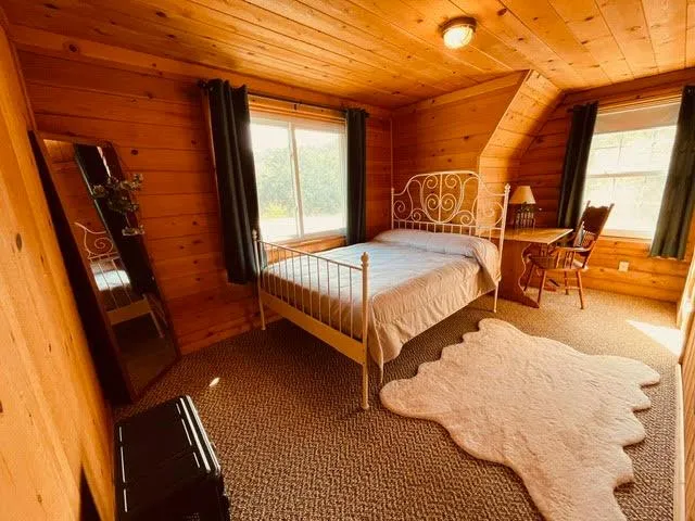 a bedroom with bed and window