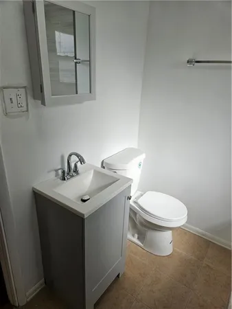 a white toilet sitting next to a bathroom sink