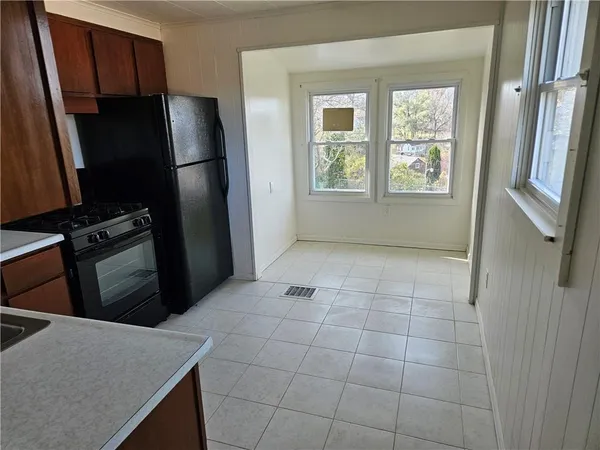 a kitchen with windows and refrigerator
