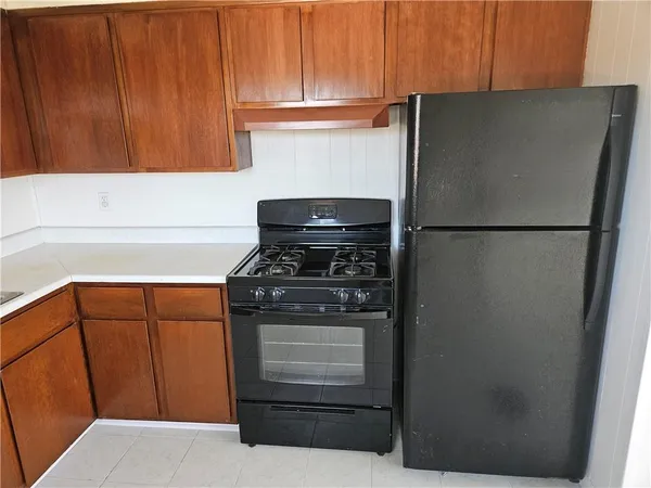 a kitchen with refrigerator and cabinets