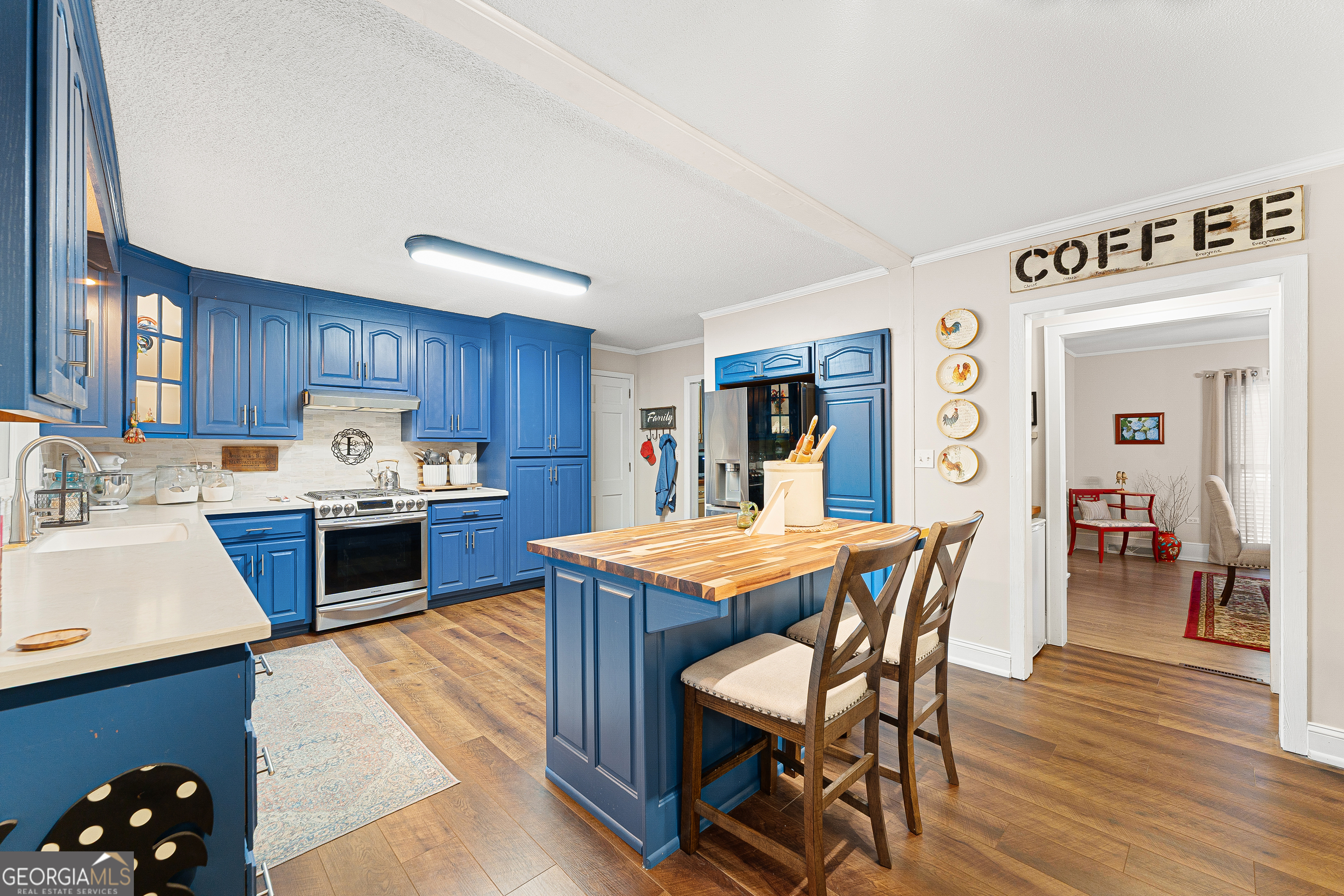 470 Benson Street Hartwell, GA 30643 - Photo 13 of 58 a kitchen with stainless steel appliances kitchen island granite countertop a table chairs sink and cabinets