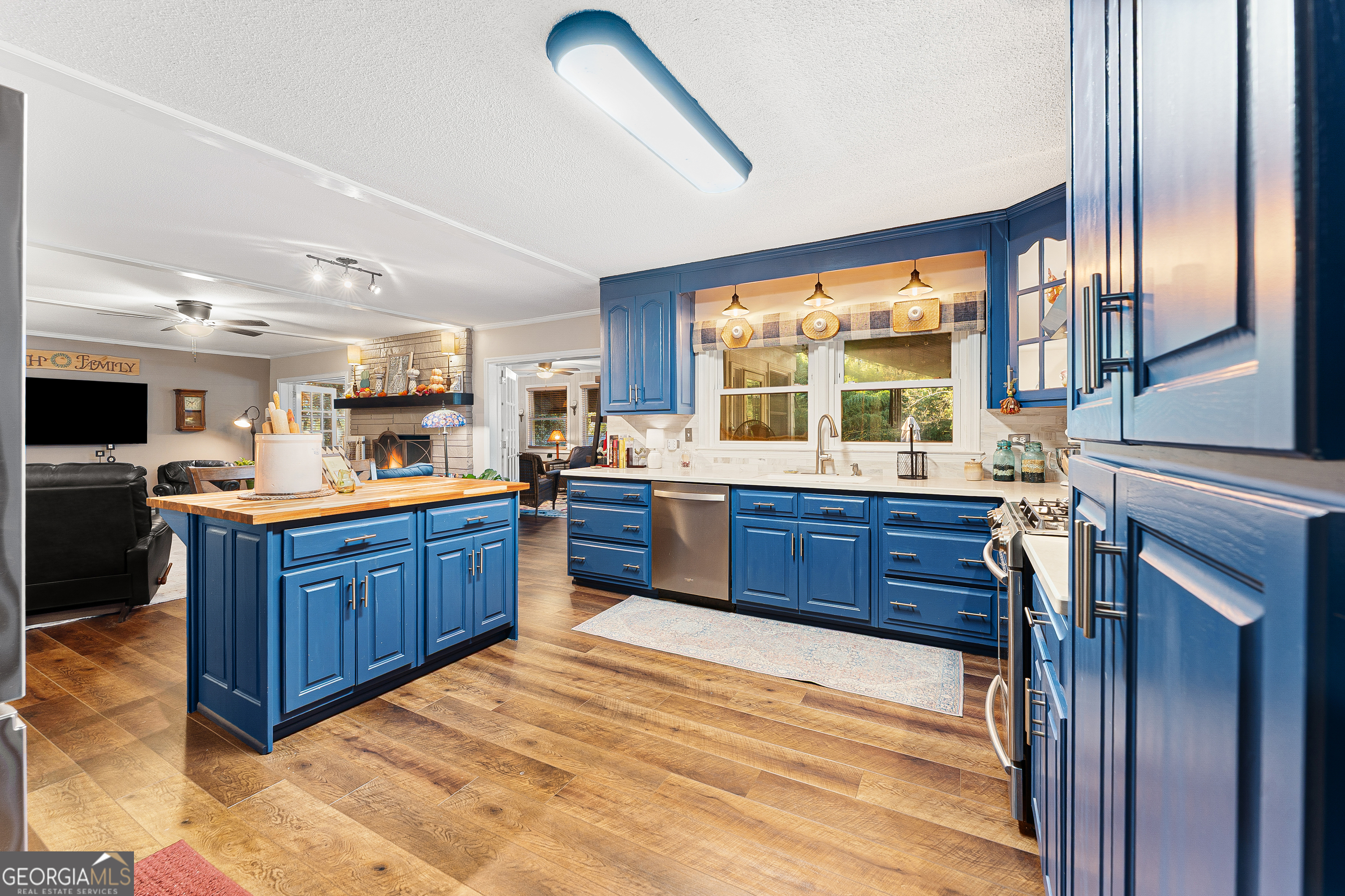 470 Benson Street Hartwell, GA 30643 - Photo 14 of 58 a kitchen with stainless steel appliances kitchen island granite countertop a stove a sink and a refrigerator