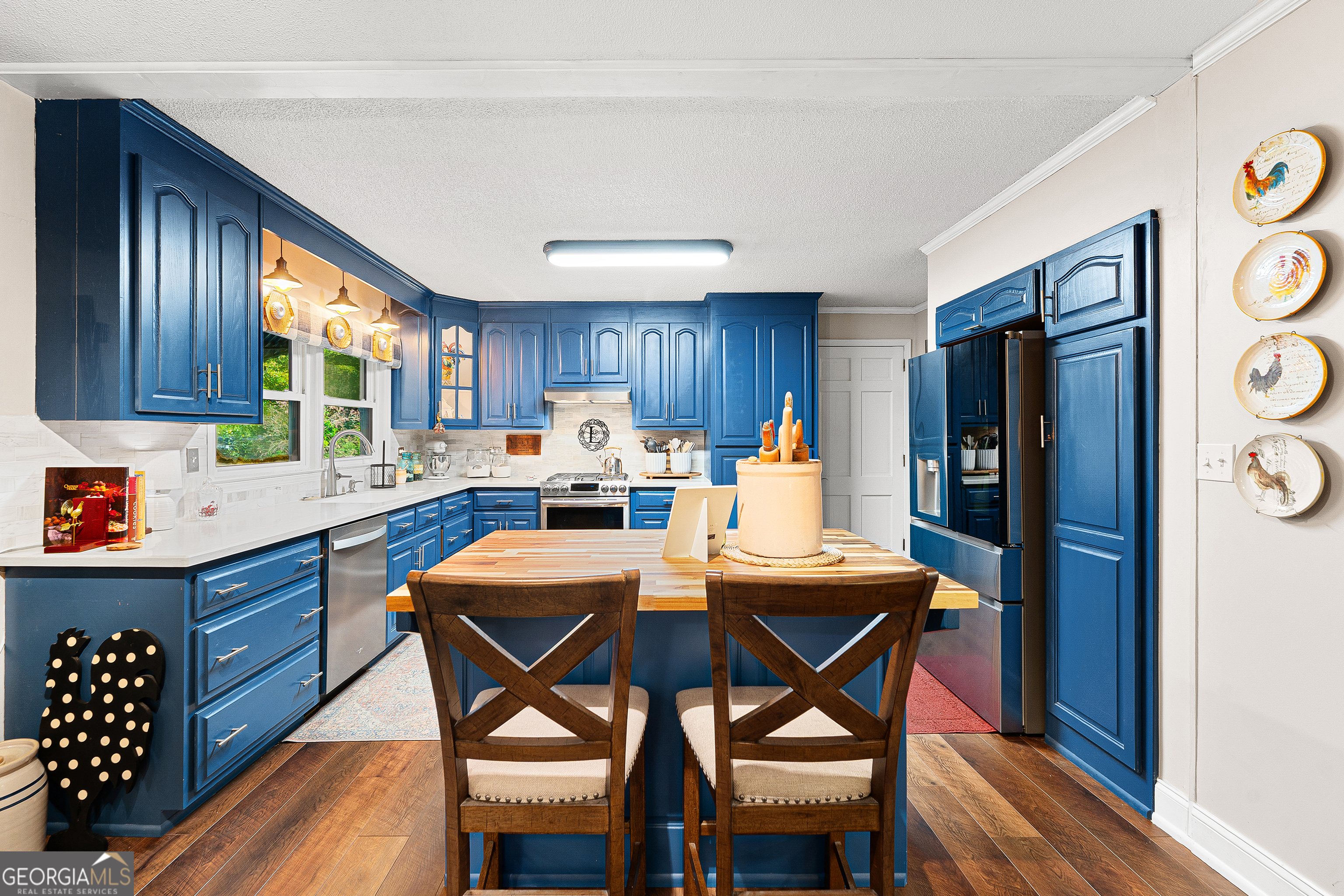 470 Benson Street Hartwell, GA 30643 - Photo 17 of 58 a kitchen with stainless steel appliances wooden floors and wooden cabinets