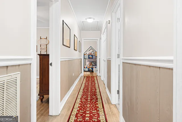 a bedroom with a bed a chandelier and a window