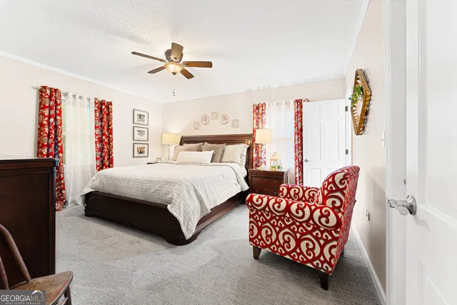 a bedroom with bed and a chandelier