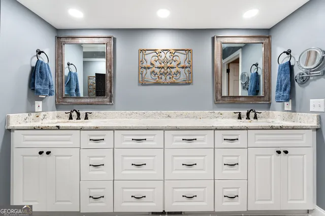 a spacious bathroom with a granite countertop sink mirror and a