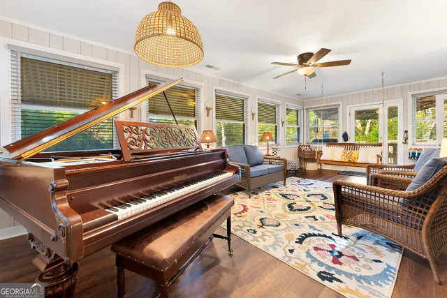 a bedroom with a large bed a flat tv screen and a dresser