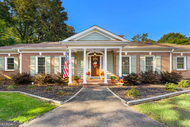a view of a house with sitting area and garden