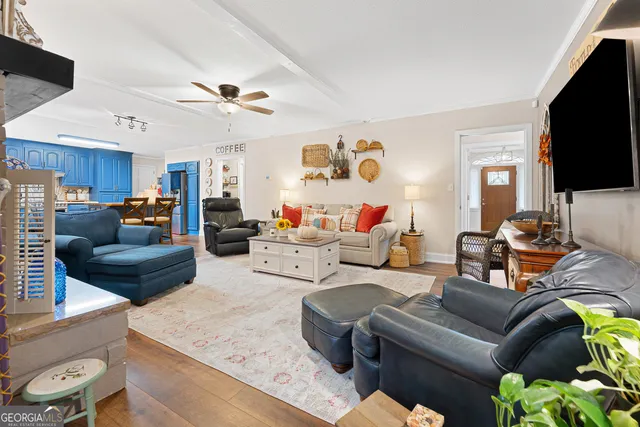 a living room with furniture a fireplace and a flat screen tv
