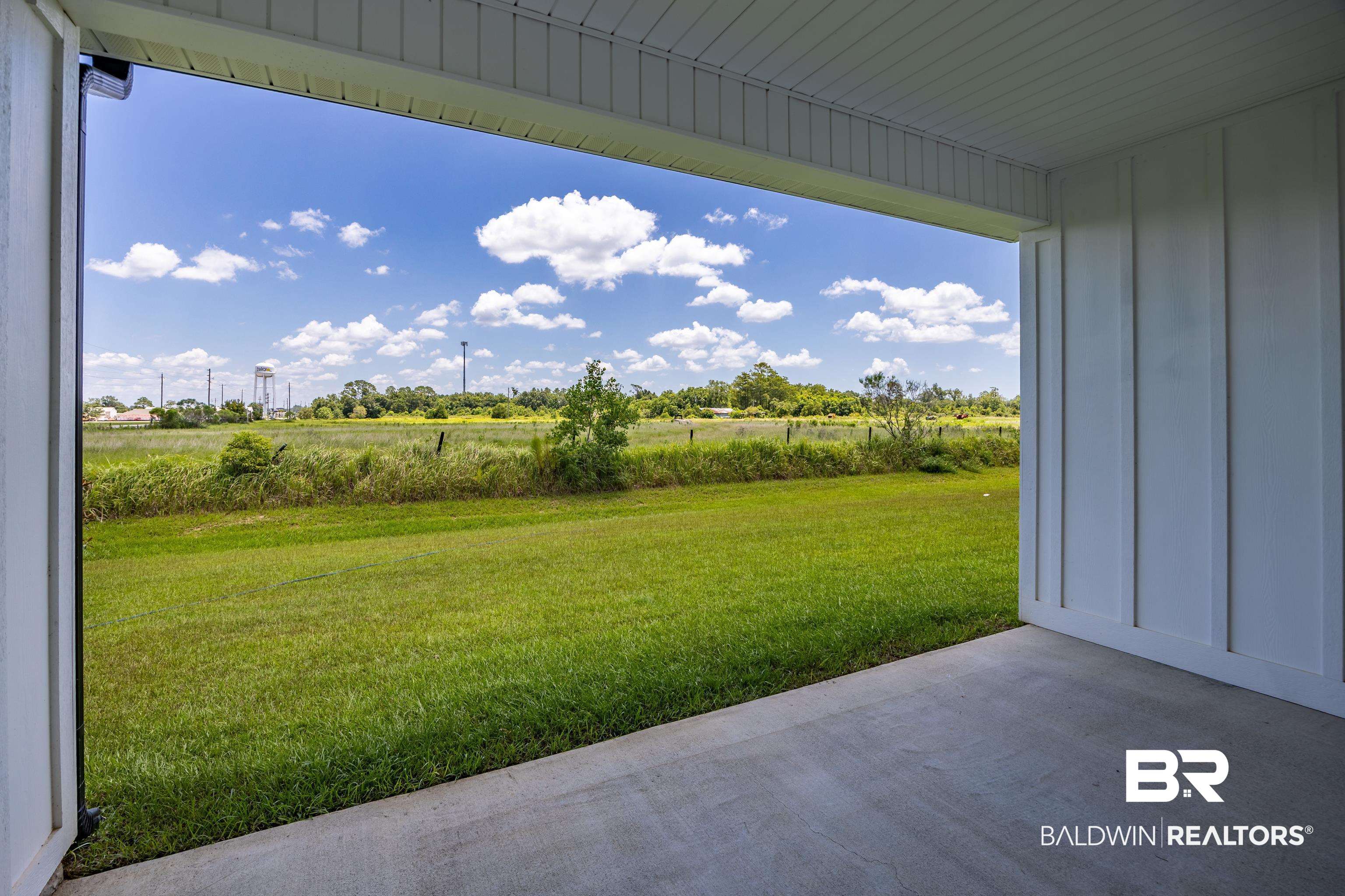 9986 Weller Cove Foley, AL 36535 - Photo 29 of 43 View of green lawn featuring a patio area and a view of rural / pastoral area