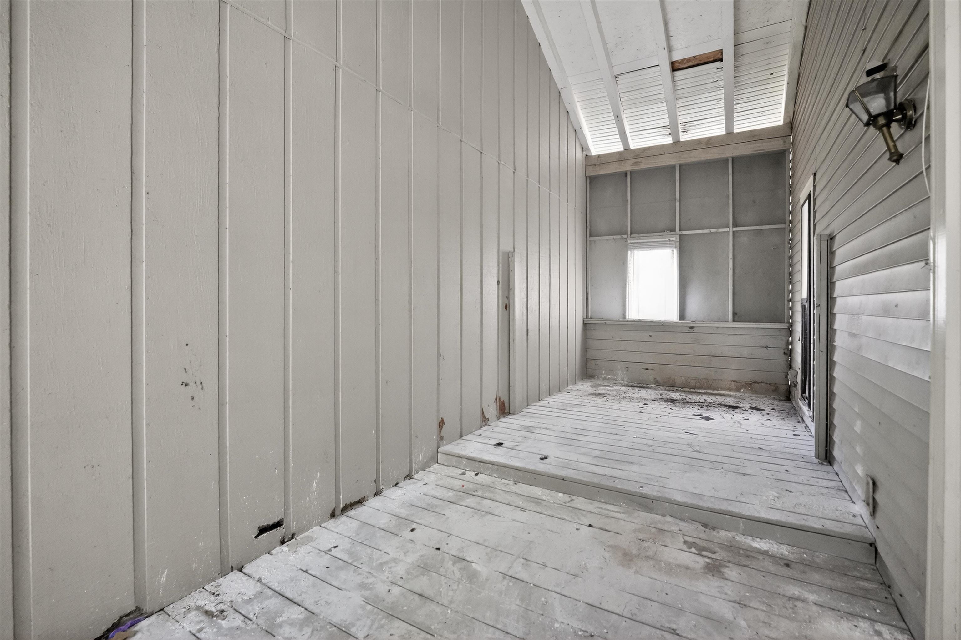 3372 Spring Shadow Drive Memphis, TN 38118 - Photo 16 of 35 Covered outdoor porch featuring wood plank flooring, horizontal and vertical paneling, and an exterior wall lantern