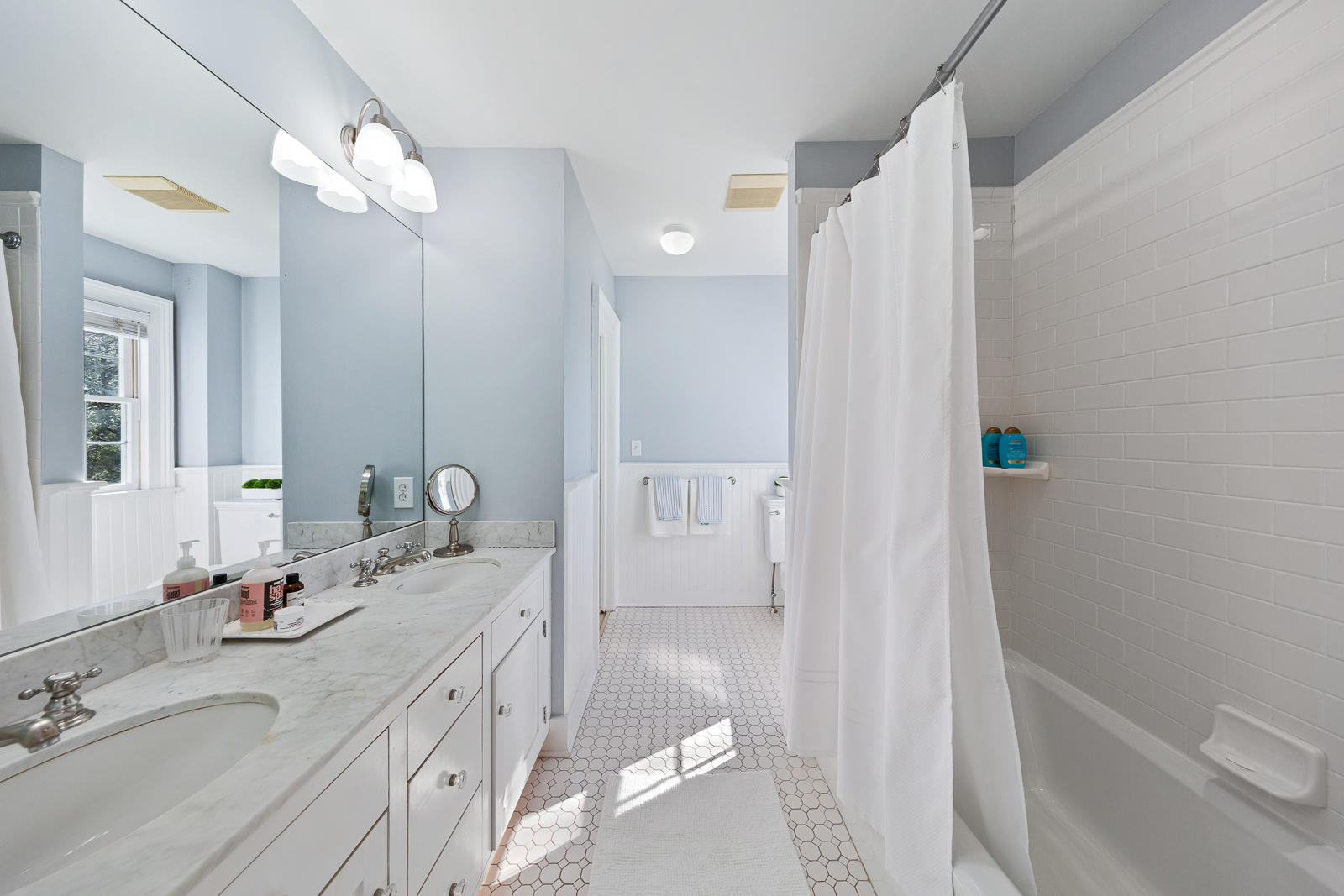8 Rings End Road Darien, CT 06820 - Photo 22 of 42 a bathroom with a double vanity sink a mirror and a bathtub