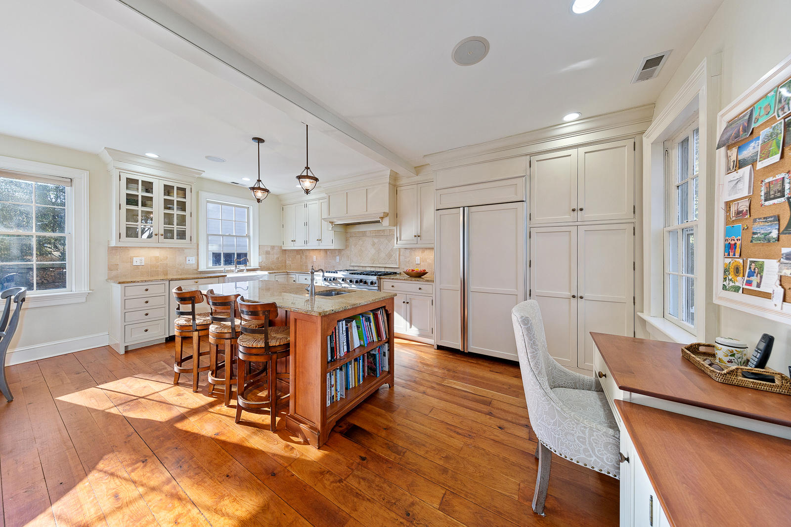 8 Rings End Road Darien, CT 06820 - Photo 7 of 42 a kitchen with stainless steel appliances a dining table chairs and wooden floor