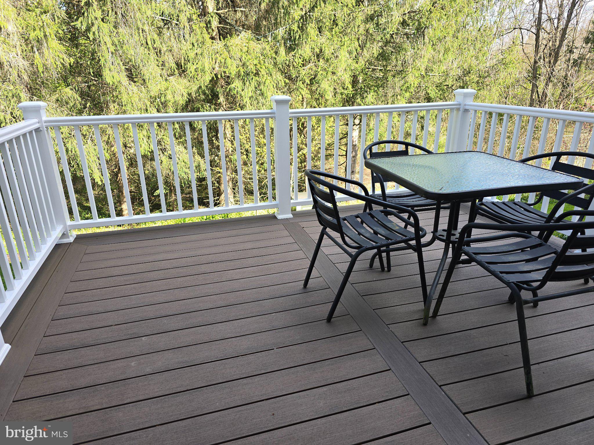 107 Keystone Hls Road, Unit 404 Factoryville, PA 18419 - Photo 24 of 27 Serene deck with lush green backdrop.