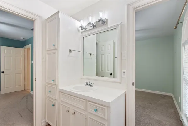 a bathroom with a sink a light fixture and a mirror
