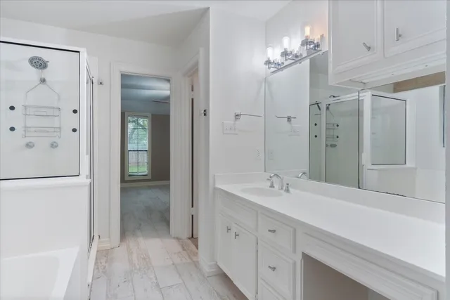 a spacious bathroom with a double vanity sink shower and a mirror