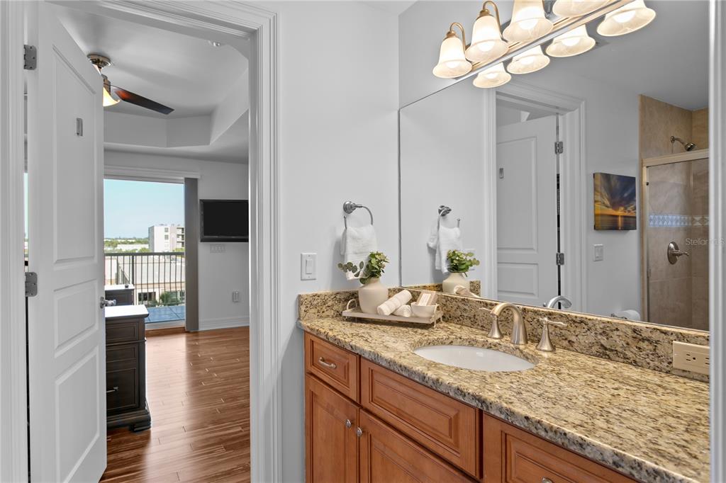 19730 Gulf Boulevard, Unit 400 Indian Rocks Beach, FL 33785 - Photo 61 of 90 a bathroom with a granite countertop sink and a mirror