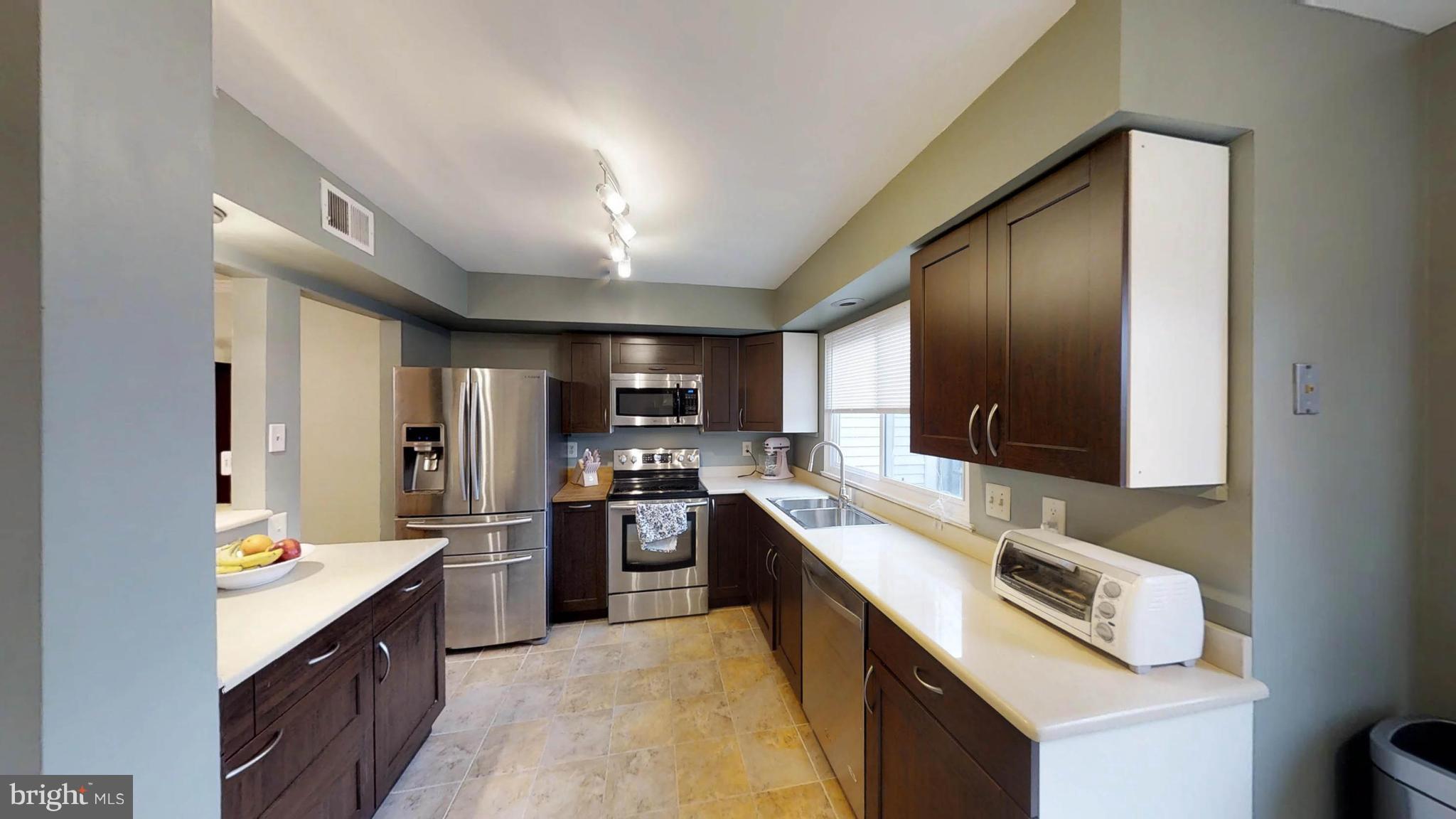 14924 Habersham Circle Silver Spring, MD 20906 - Photo 15 of 27 a large kitchen with a large counter top appliances and cabinets