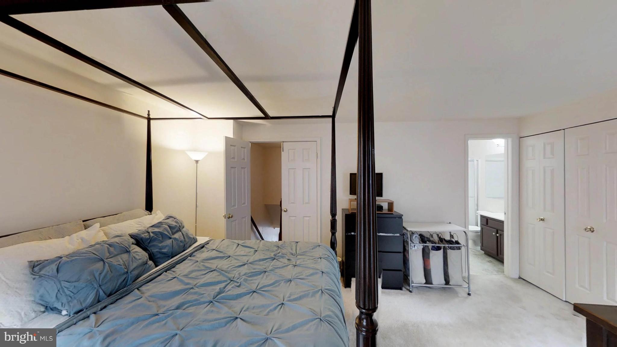 14924 Habersham Circle Silver Spring, MD 20906 - Photo 19 of 27 a bedroom with a bed and a chandelier