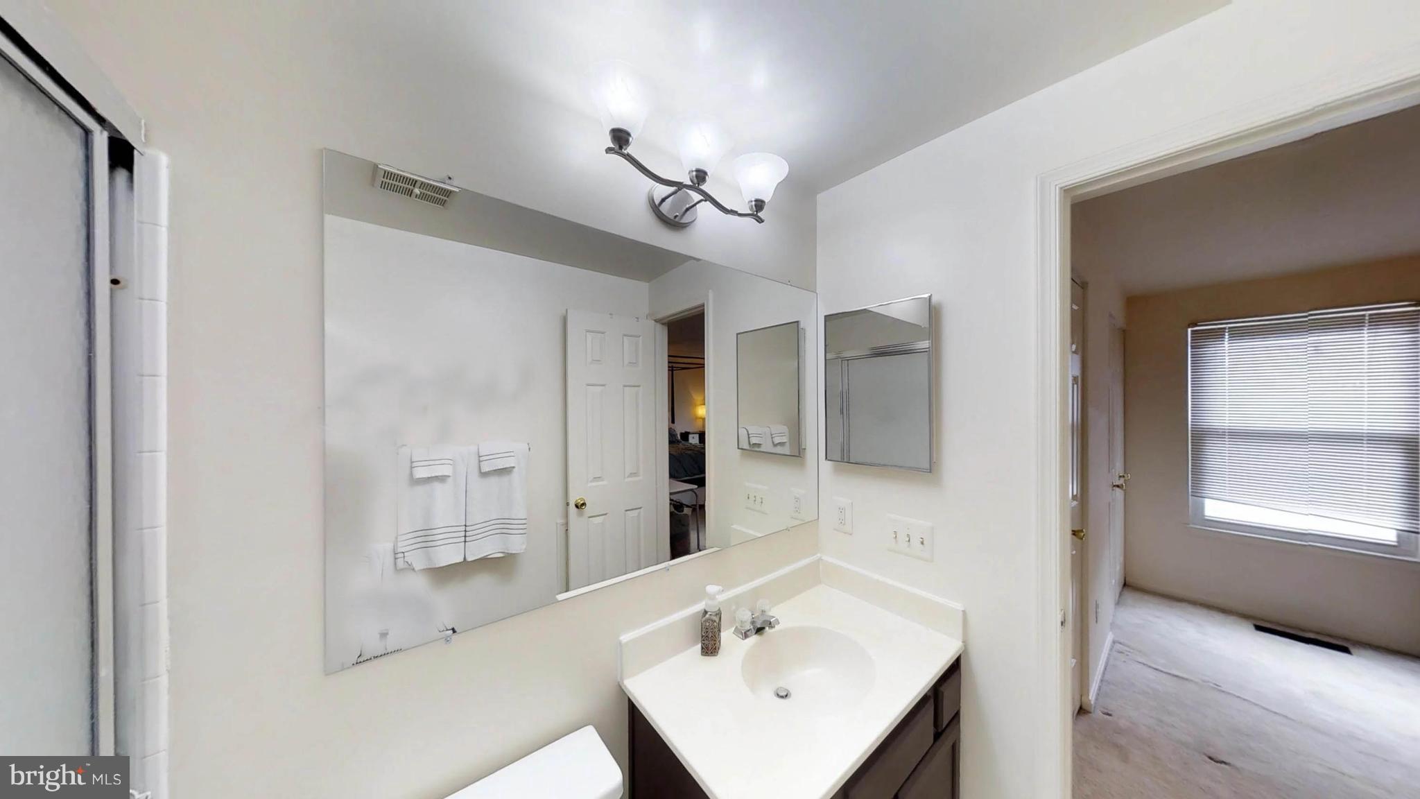 14924 Habersham Circle Silver Spring, MD 20906 - Photo 21 of 27 a bathroom with a sink a light fixture and a mirror