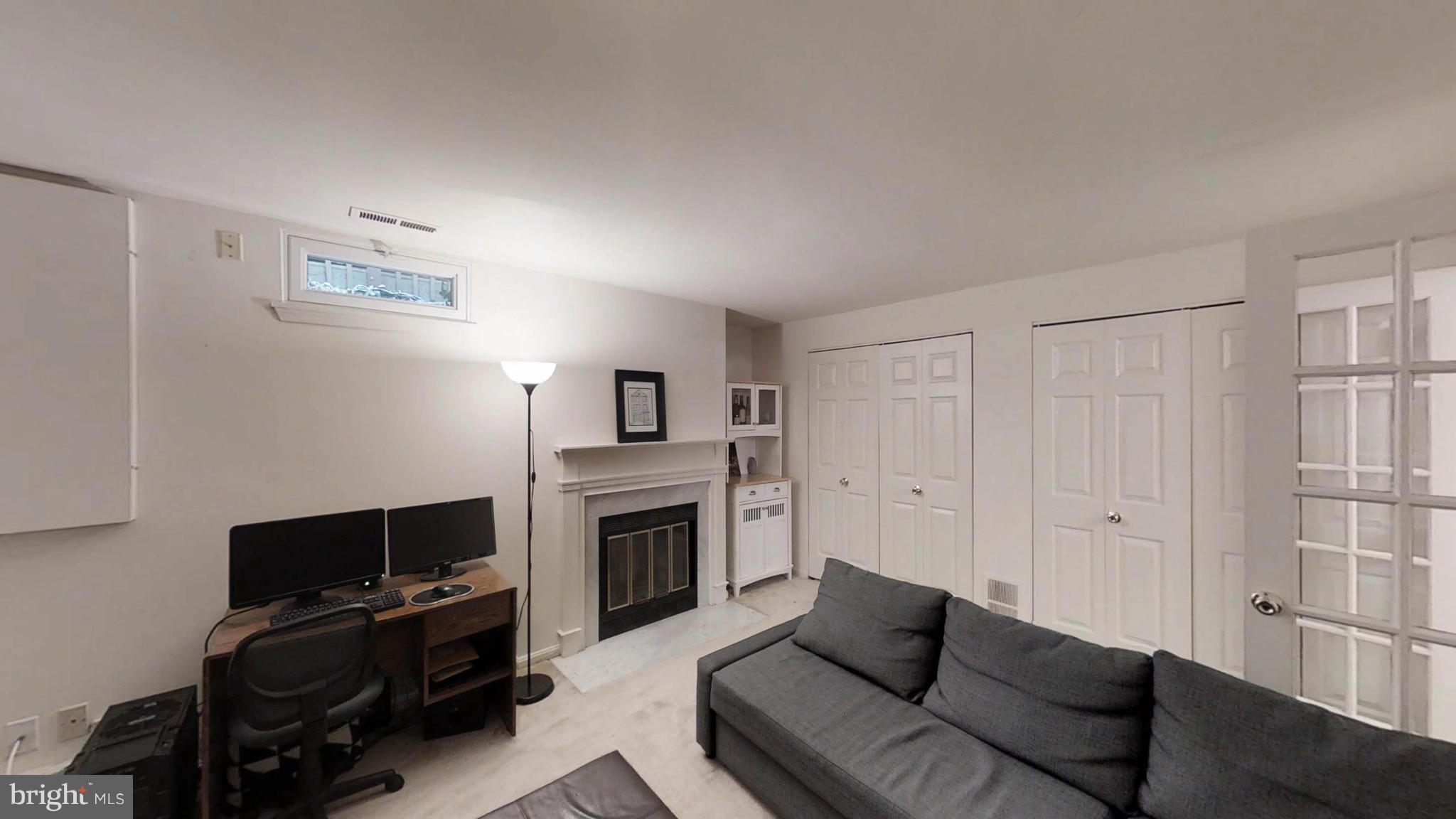 14924 Habersham Circle Silver Spring, MD 20906 - Photo 5 of 27 a living room with furniture a flat screen tv and a fireplace