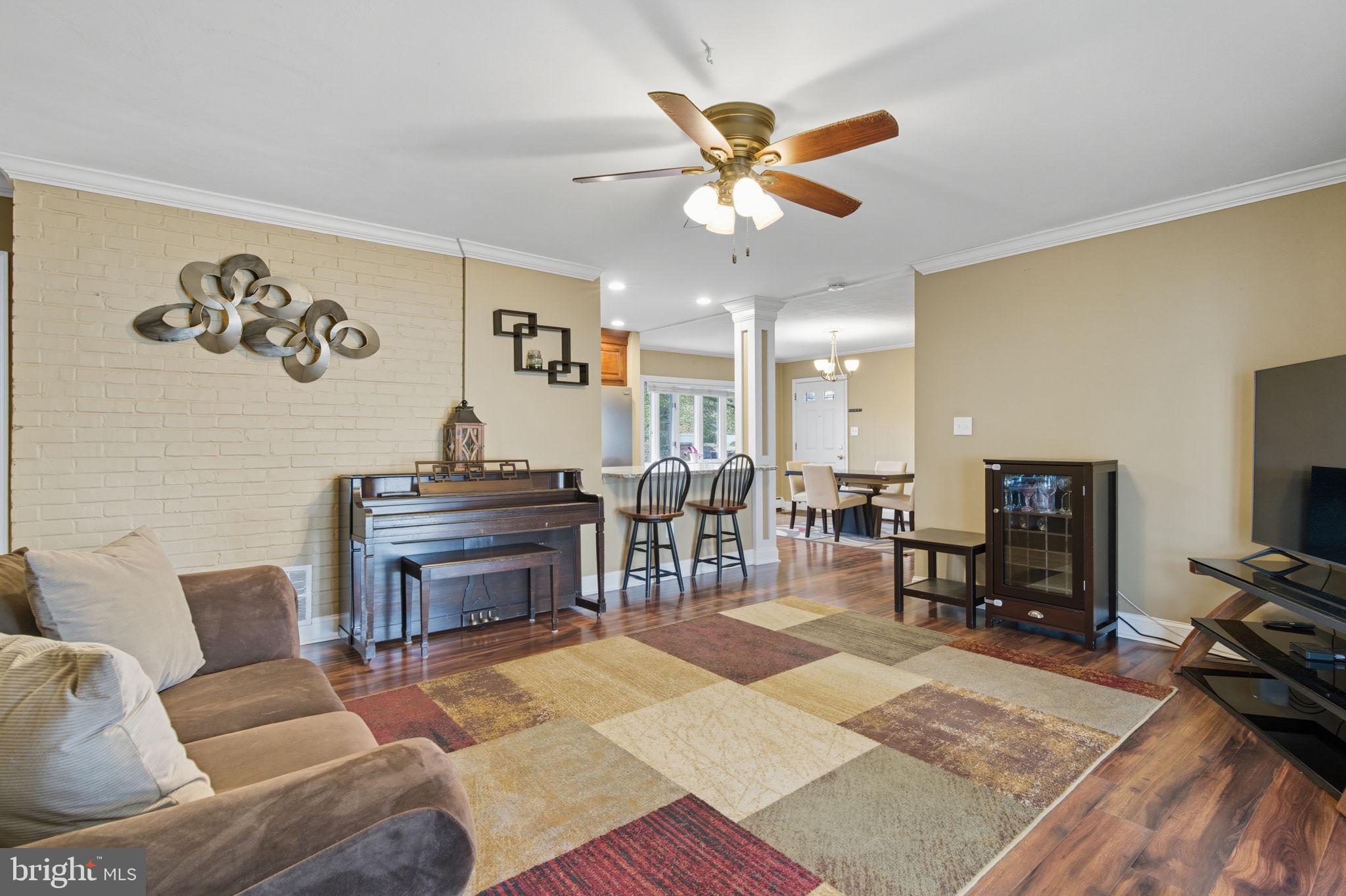 9 Newberry Lane Levittown, PA 19054 - Photo 36 of 36 a living room with furniture a piano and a flat screen tv